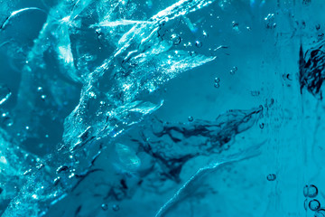 Ice texture background macro close up in sunlight. Beautiful abstract patterns of frozen water.