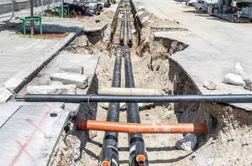 District heating pipeline reparation and reconstruction site parallel with the street with...