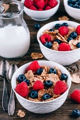 Whole Grain cereals with fresh blueberries and raspberries for breakfast.