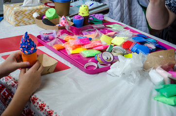 Model of ice cream, created by children from plasticine. Air plasticine on the table.