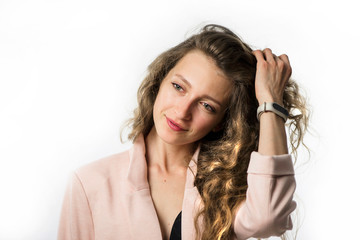 pretty stylish young girl model with long curly hair in a jacket on a white background