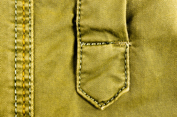 clothing items stonewashed cotton fabric texture with seams, clasps, buttons and rivets, macro