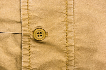 clothing items stonewashed cotton fabric texture with seams, clasps, buttons and rivets, macro