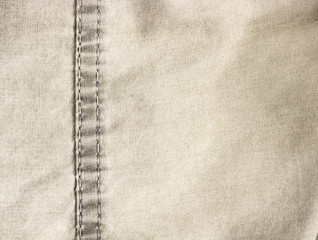 clothing items stonewashed cotton fabric texture with seams, clasps, buttons and rivets, macro