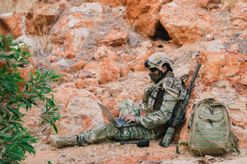Soldiers of special forces on wars at the desert,Thailand people,Army soldier use laptop for see...