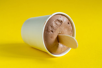 Paper cup with chocolate ice cream, just out of the freezer.