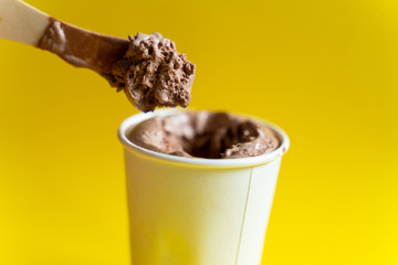 Paper cup with chocolate ice cream, just out of the freezer.