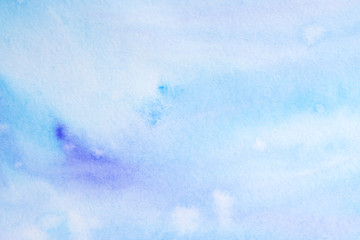 watercolor background filled blue light transparent with drips of paint spread over the paper. on textured watercolor paper paint