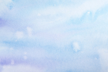 watercolor background filled blue light transparent with drips of paint spread over the paper. on textured watercolor paper paint