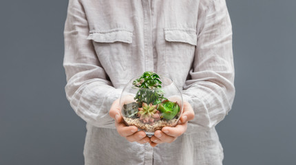 Woman holding mini glass florarium