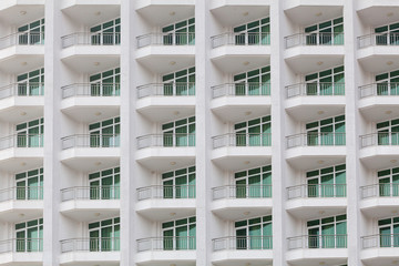 repeating pattern of windows and balcony. Bulding front