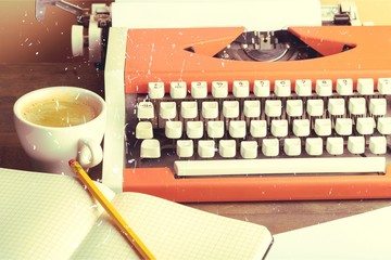 Old typewriter with paper and coffee  on background