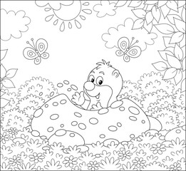 Funny little mole digging its small burrow in a garden on a sunny summer day, black and white vector illustration in a cartoon style for a coloring book