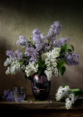 Bouquet of lilac flowers in an old Japanese vase. Vintage still life.
