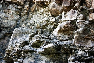 Stone breaks in the rays of sunset. Red and orange stone texture