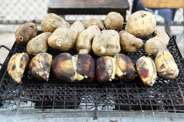 Traditional street food of Thailand - grilled bananas and sweet potato. Chiang Mai, Thailand.