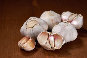 Garlic and garlic cloves on wooden background. Selective focus