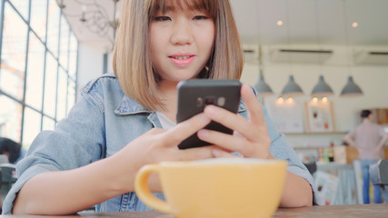 Female blogger photographing green tea cup in cafe with her phone. A young woman taking photo of coffee tea on smartphone, photographing meal with mobile camera.