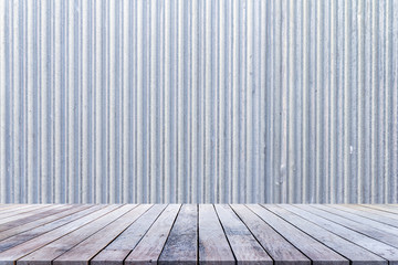 Empty old wooden table or wood floor for product placement or montage with old galvanize sheet background.