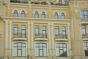 facade of a large brown house with many windows on the wall