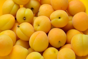 Ripe juicy orange apricots fruit background.