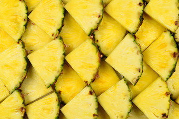 Pineapple juicy yellow slices background. Top view.