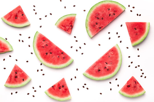 Sliced watermelon and seeds on white background