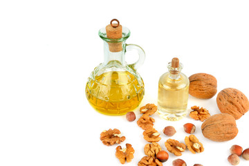 Oil of walnut and hazelnut, nut fruit isolated on white background. Free space for text.