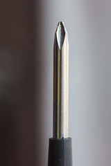head of metal crosses screwdriver close-up on a blurred background. hand tool close up. copy space. vertical