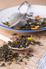 Green tea with orange peel and herbs with blue flowers