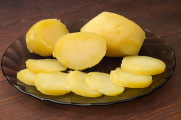 boiled potatoes on a black plate