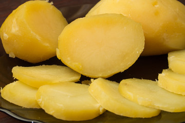 boiled potatoes on a black plate