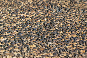 A rough wall texture of small burnt pebbles