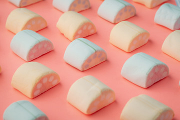 Marshmallows in the shape of fruit slices on a pink background