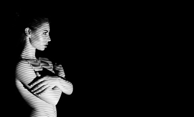 Elegant naked lady with striped shadow on her body
