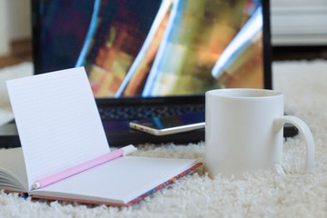 Top view of white office desk table with laptop, phone, coffee. Flat lay with empty space