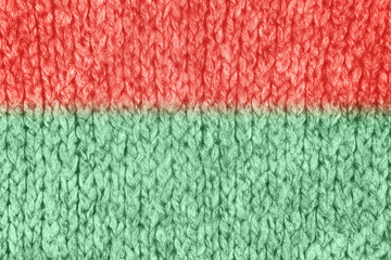 Loose Knitwear Fabric Texture with wool fibers. Repeating Machine Knitting Texture of warm Sweater. Trendy duo tone coral and mint colored Knitted Background.