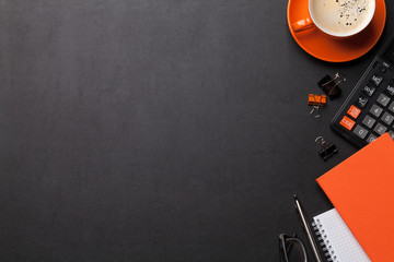 Office workplace with coffee, supplies and calculator