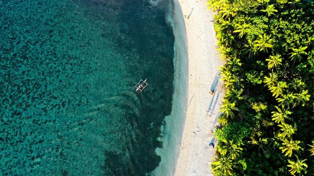 Top down view of tropical beach with turquoise water and white sand
