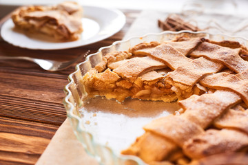 Eating sweet food context. Traditional holidays apple pie, slice on white plate and apples. Relishing sweet treats