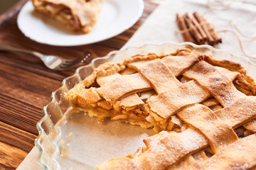 Tasty homemade apple pie. American pie. Apples. Cinnamon. Plate. Linen towel. Wooden background. Top view