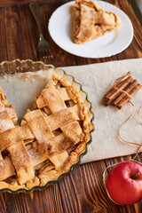 Fototapeta na wymiar Tasty homemade apple pie. American pie. Apples. Cinnamon. Plate. Linen towel. Wooden background. Top view