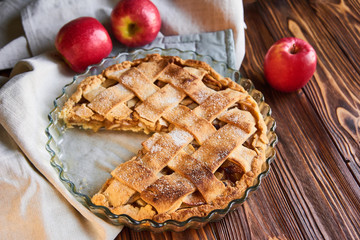 baked food : apple pie served with fresh apples on white plate on wooden table