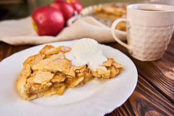 A finished plate and spoon, after eating apple pie a la mode. Part of a series of images showing the preparation of traditional apple pie.
