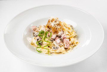 Carbonara pasta, spaghetti with pancetta, egg, hard parmesan cheese and cream sauce.