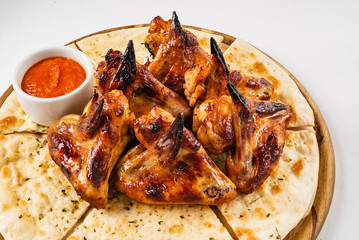 tasty grilled chicken wings with sauce