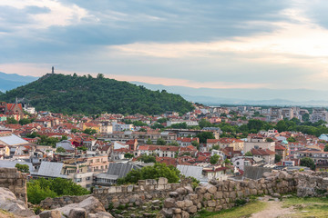 Fototapeta na wymiar Part of ancient fortress wall on top of the Nebet tepe Hill in Plovdiv city, Bulgaria. Panoramic view with warm sunset.