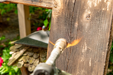 gas burner with hot flame on a wooden pallet to flame it down