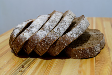 Black rye bread sliced ​​on a wooden board