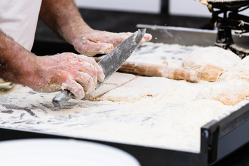 A man makes Irish traditional soda bread farls, common in most of Ireland, but particularly in Northern Ireland.